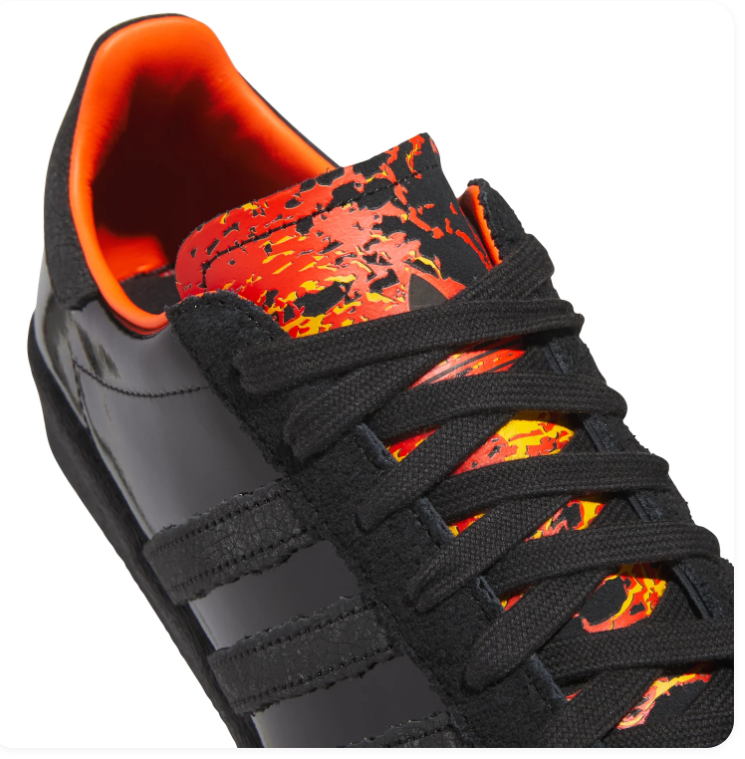 Adidas Black Low-Top Sneakers with Orange Lining and Graphic Tongue